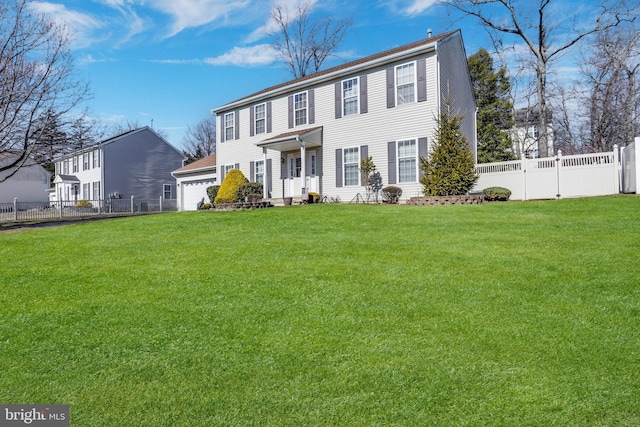 colonial home featuring fence and a front lawn