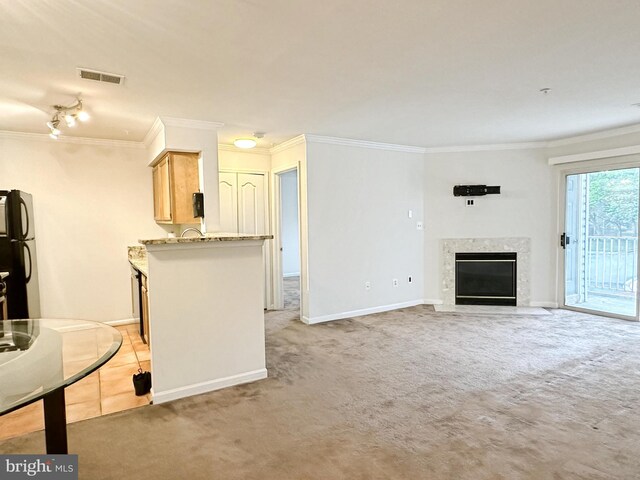 8961 Town Center Cir Unit 1-203, Upper Marlboro, MD 20774 - kitchen with crown molding, freestanding refrigerator, light carpet, a high end fireplace, and baseboards