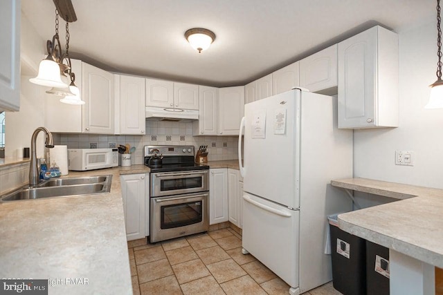 kitchen with white appliances, white cabinets, a sink, under cabinet range hood, and backsplash