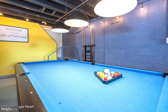 playroom with concrete block wall and pool table