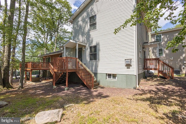 rear view of property with stairs