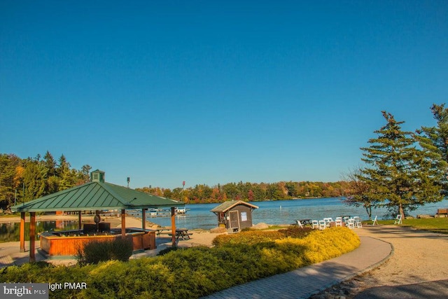 view of property's community with a water view and a gazebo