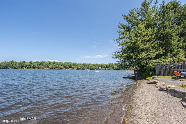 property view of water featuring fence