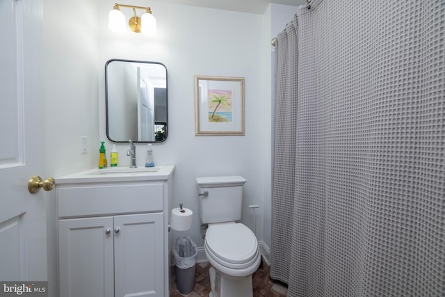 full bathroom featuring vanity, toilet, and baseboards