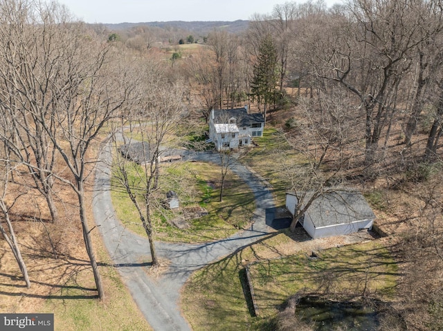 birds eye view of property with a view of trees