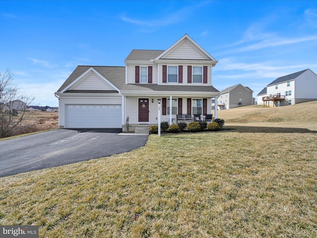 traditional-style home featuring a garage, covered porch, aphalt driveway, and a front yard