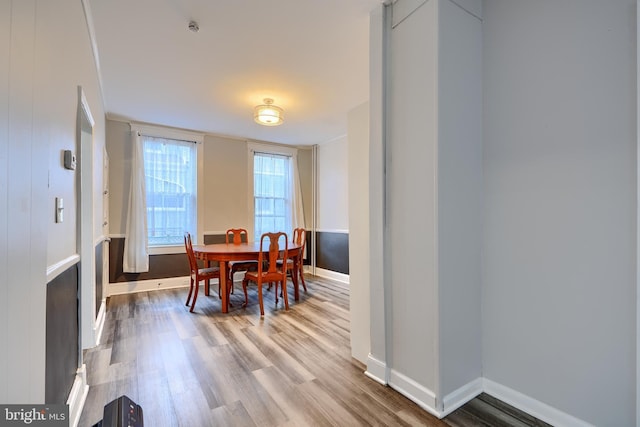 dining room featuring wood finished floors and baseboards