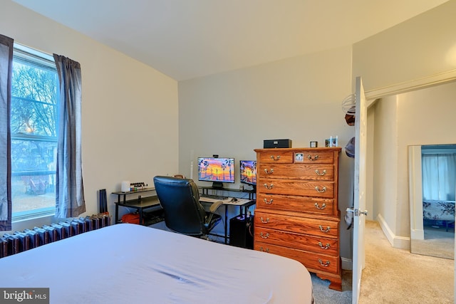 bedroom featuring radiator, baseboards, and light colored carpet