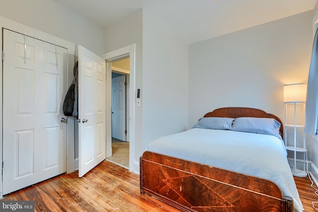 bedroom featuring baseboards and wood finished floors