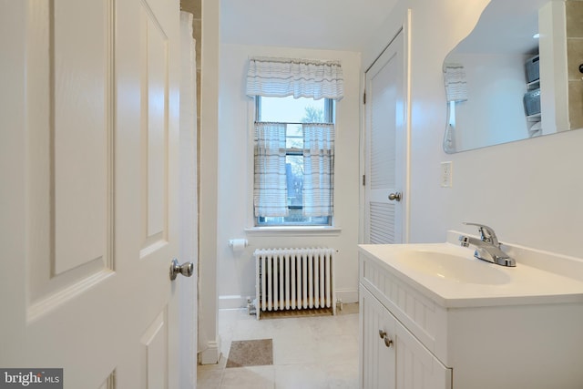 full bath with tile patterned flooring, radiator, vanity, and baseboards