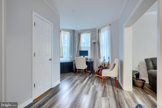 home office with baseboards, ornamental molding, and wood finished floors