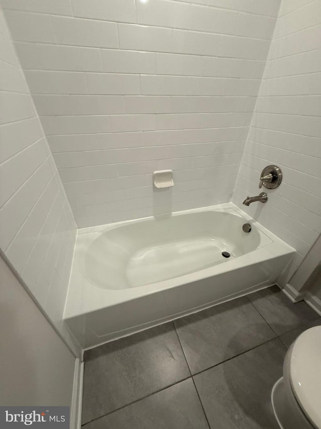 bathroom with shower / tub combination, toilet, and tile patterned floors