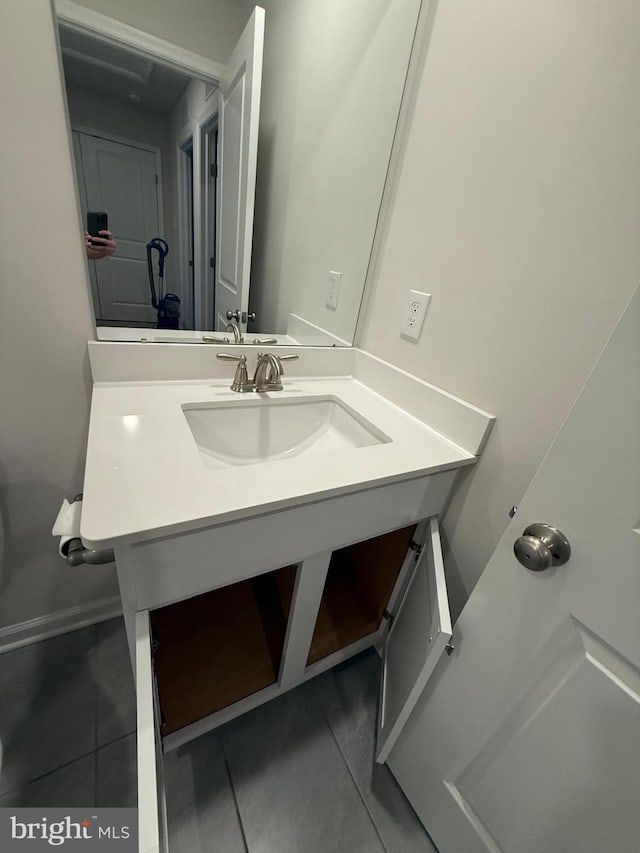 bathroom featuring tile patterned flooring and vanity