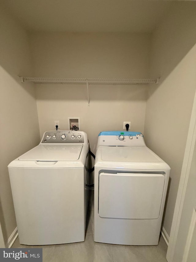 washroom featuring laundry area and separate washer and dryer