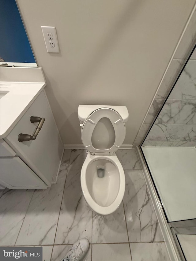 full bathroom featuring baseboards, toilet, marble finish floor, vanity, and a shower stall