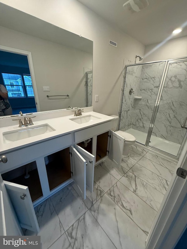 full bath featuring marble finish floor, a marble finish shower, and a sink