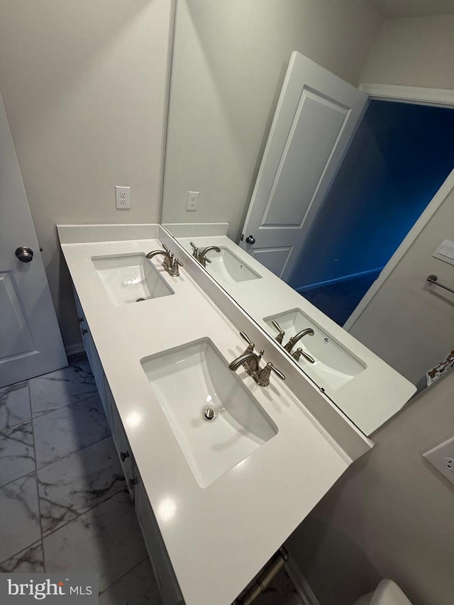 full bathroom featuring marble finish floor and a sink