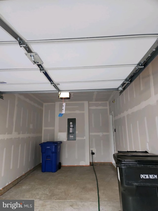 garage featuring electric panel and a garage door opener