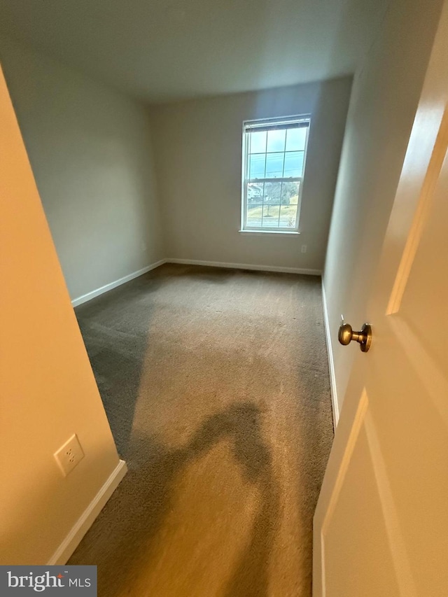 empty room with carpet floors and baseboards