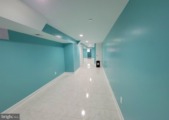 hall with recessed lighting, marble finish floor, visible vents, and baseboards