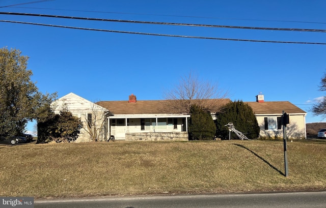 ranch-style house with a front lawn and a chimney