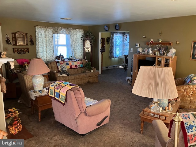 living area featuring baseboard heating and carpet flooring