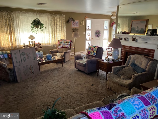 living room with carpet floors, ceiling fan, a fireplace, and visible vents