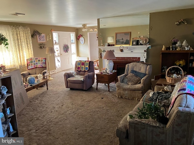 carpeted living area with a fireplace and visible vents