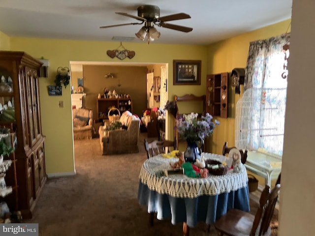 dining space featuring carpet floors and ceiling fan