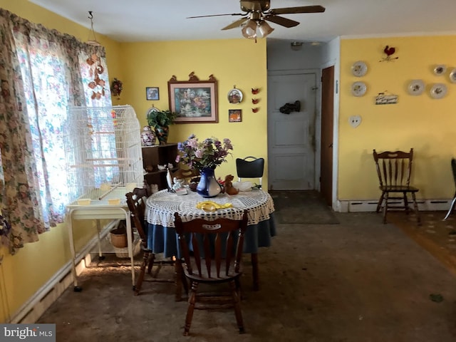 dining space featuring a baseboard radiator and ceiling fan