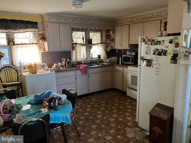 kitchen with white appliances, washer / clothes dryer, open shelves, and a sink