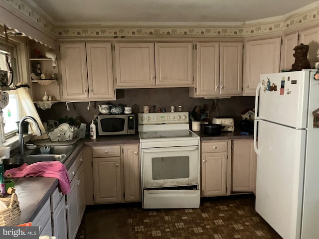 kitchen with dark countertops, white appliances, a sink, and open shelves