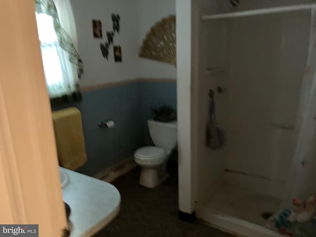 full bath with a stall shower and toilet