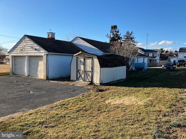 garage featuring a storage shed and heating fuel