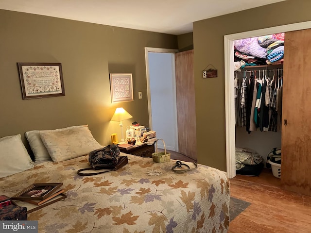 bedroom with a closet and wood finished floors