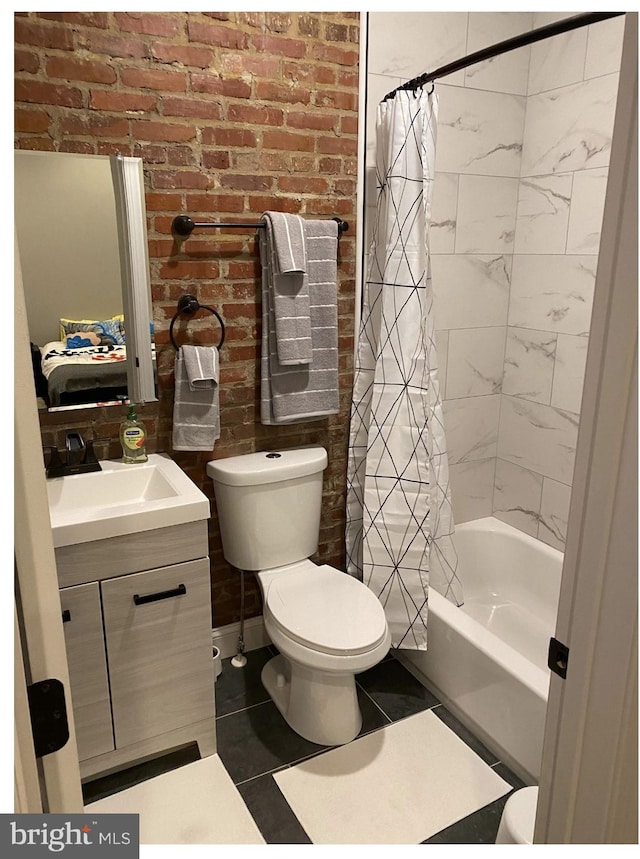 full bathroom featuring toilet, shower / tub combo, brick wall, and vanity