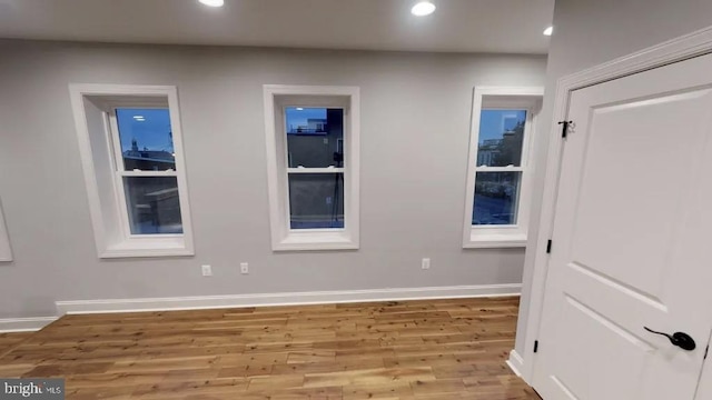 interior space with recessed lighting, baseboards, and wood finished floors