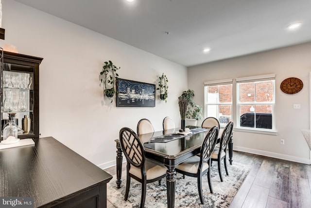 dining space featuring recessed lighting, baseboards, and wood finished floors