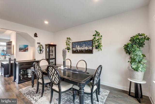 dining area with baseboards, wood finished floors, and recessed lighting