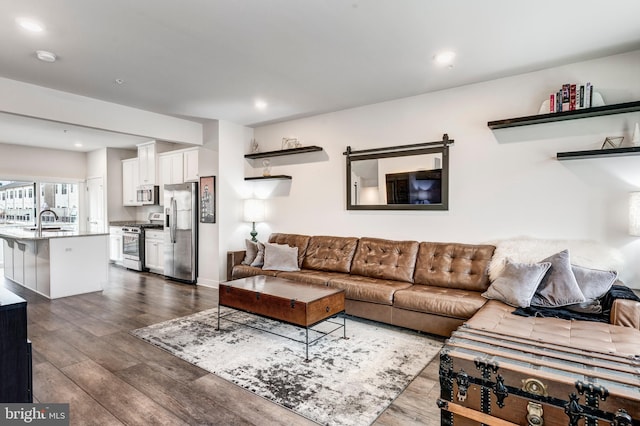 living room featuring recessed lighting and dark wood finished floors