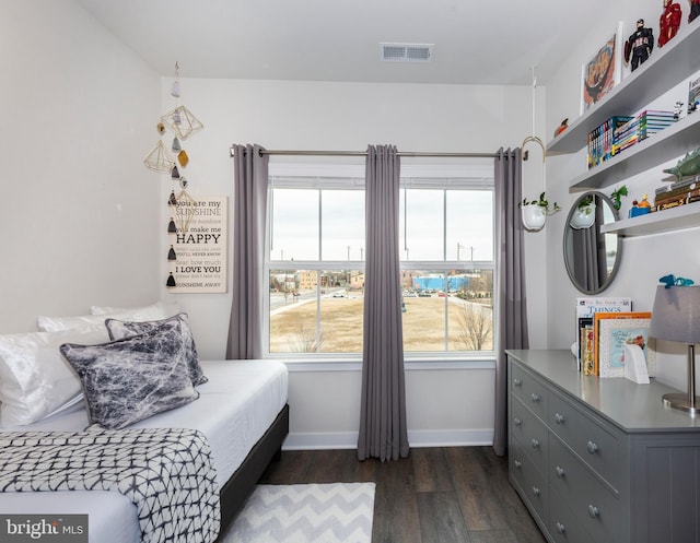 bedroom featuring dark wood-style floors, baseboards, and visible vents