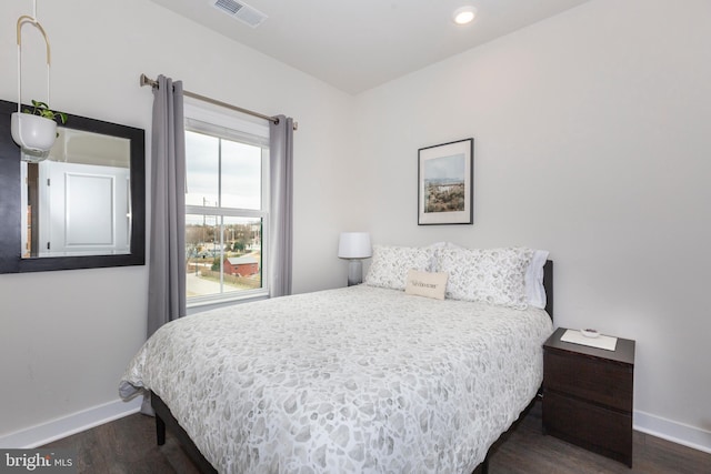 bedroom with recessed lighting, visible vents, baseboards, and wood finished floors