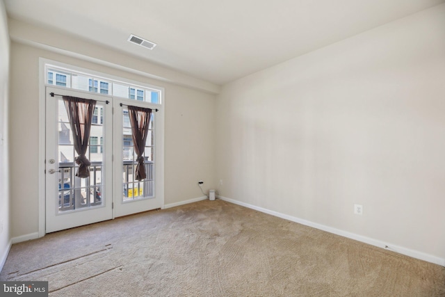 unfurnished room with baseboards, visible vents, and carpet flooring