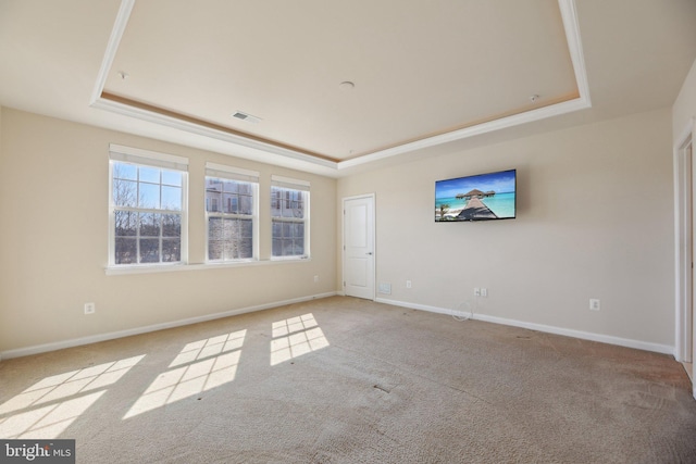 unfurnished room featuring a raised ceiling, visible vents, and baseboards