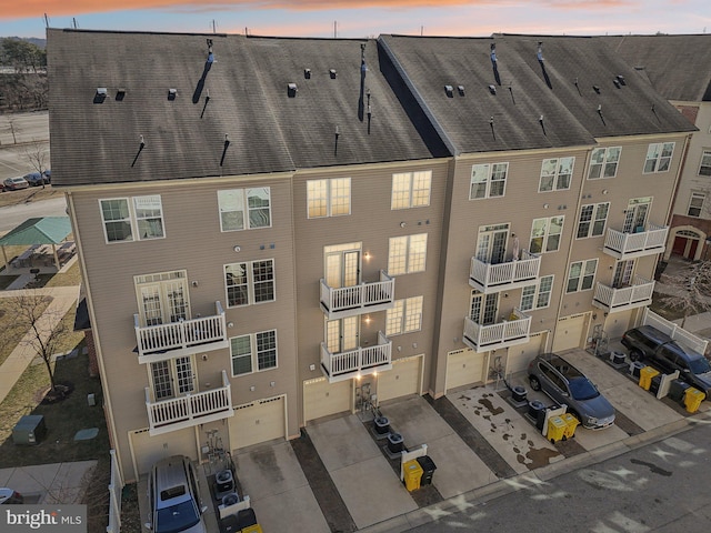 view of building exterior with driveway and a garage