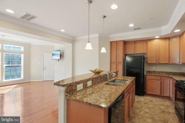 kitchen featuring black appliances, crown molding, visible vents, and a sink