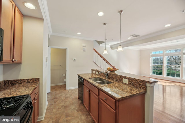 kitchen featuring ornamental molding, brown cabinetry, a sink, dark stone countertops, and black appliances