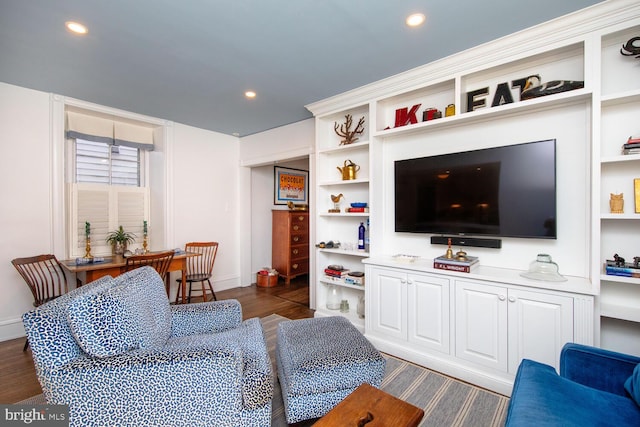 living room featuring dark wood-style floors, built in shelves, and recessed lighting