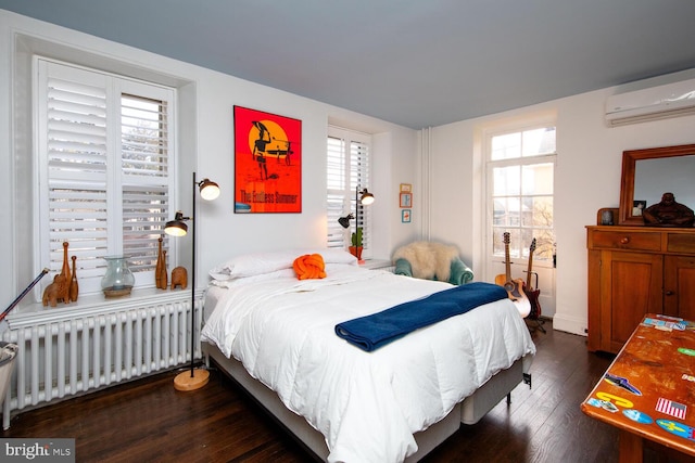 bedroom with multiple windows, a wall mounted AC, hardwood / wood-style flooring, and radiator