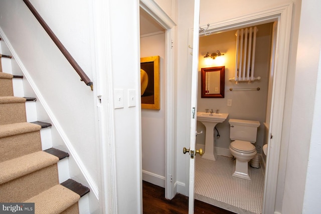 bathroom featuring toilet and baseboards